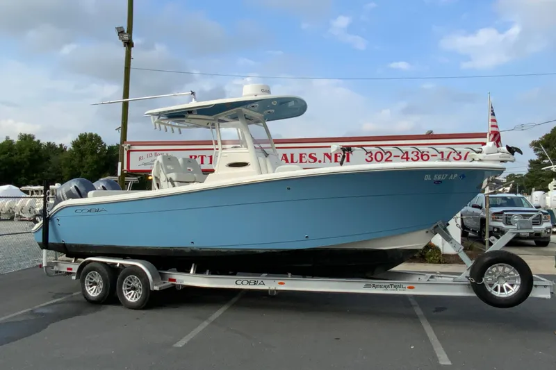 Slide: The Image of 2023 Cobia 262 Center Console boat on trailer, displayed outdoors. - 4