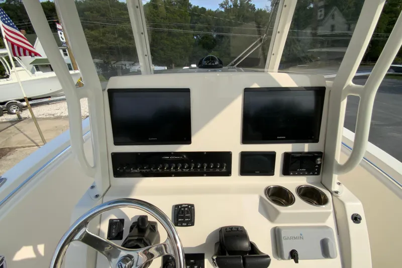 Slide: The Image of 2023 Cobia 262 Center Console dashboard with dual Garmin displays and controls. - 40