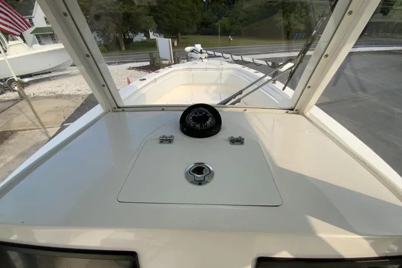 Slide: The Image of 2023 Cobia 262 Center Console boat deck with compass and hatch. - 41
