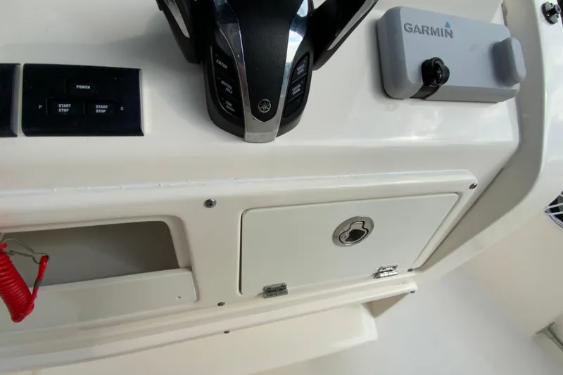Slide: The Image of 2023 Cobia 262 Center Console dashboard with Garmin device and control panel. - 43
