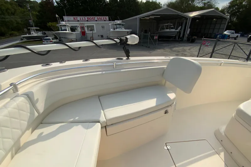 Slide: The Image of 2023 Cobia 262 Center Console boat interior with cushioned seating at RT 113 Boat Sales. - 56