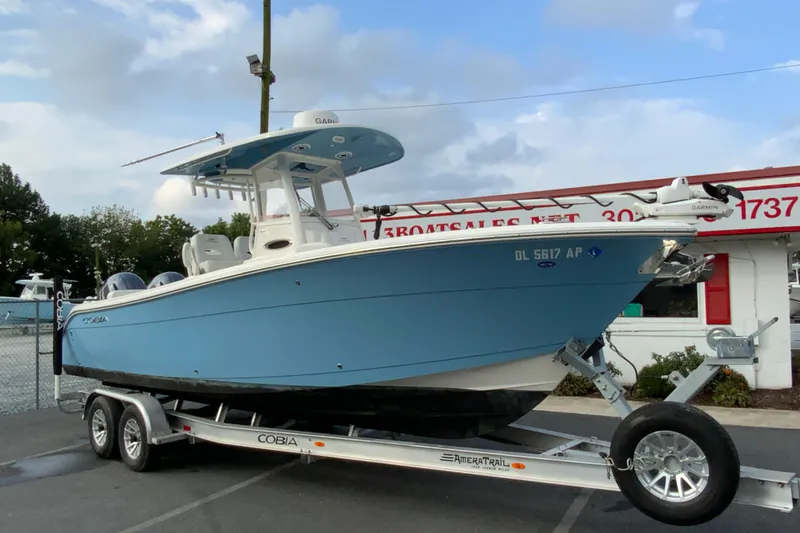 Slide: The Image of 2023 Cobia 262 Center Console boat on trailer, displayed outdoors. - 6