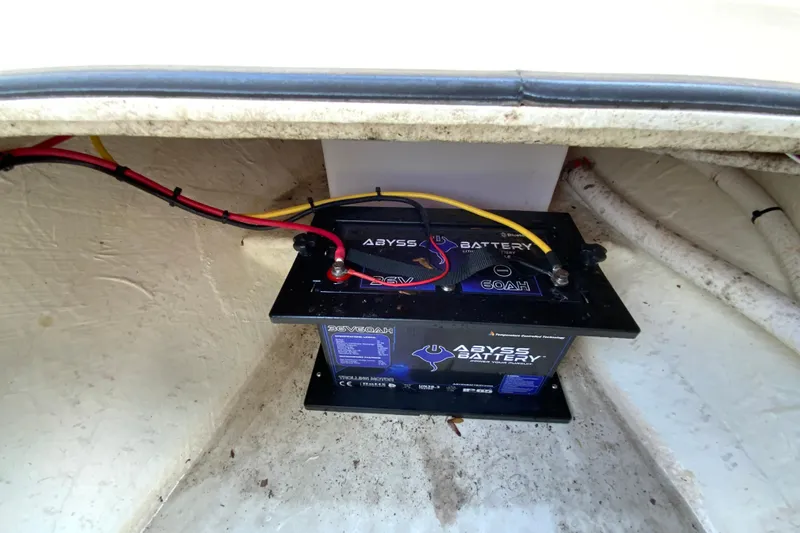 Slide: The Image of Battery compartment of 2023 Cobia 262 Center Console with Abyss Battery installed. - 60