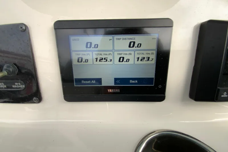 Slide: The Image of Yamaha display on 2023 Cobia 262 Center Console showing trip and fuel data. - 62