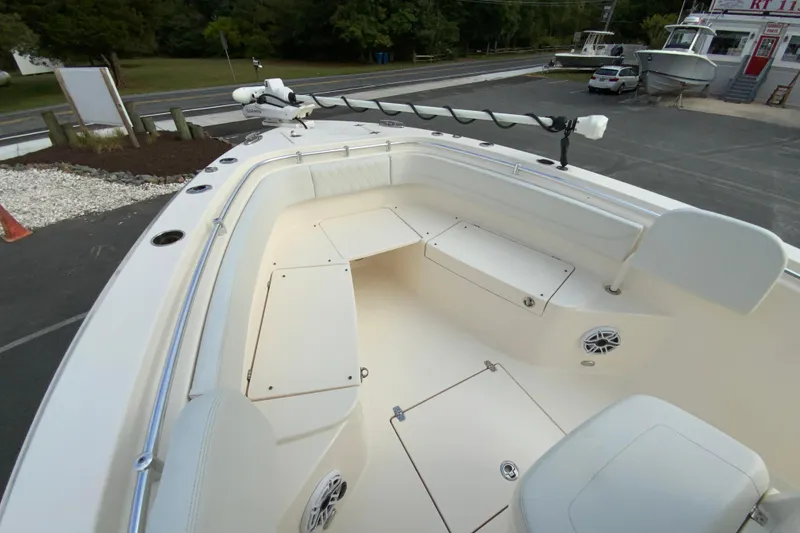 Slide: The Image of 2023 Cobia 262 Center Console boat interior with seating and storage compartments. - 64