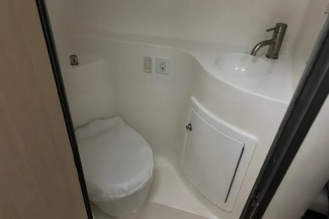 Slide: The Image of Compact bathroom in 2026 Regal 26 XO boat with toilet and sink. - 16