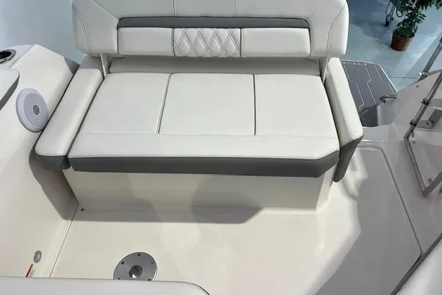 Slide: The Image of 2026 Regal 26 XO boat interior with white cushioned seating and speaker. - 4