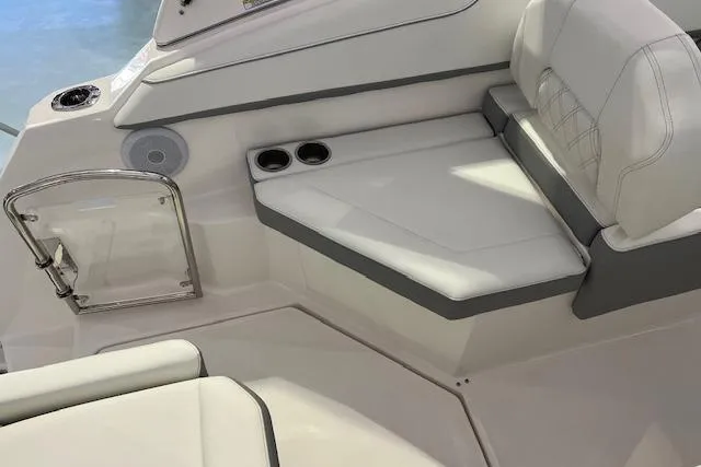 Slide: The Image of 2026 Regal 26 XO boat interior with white seating and cup holders. - 6