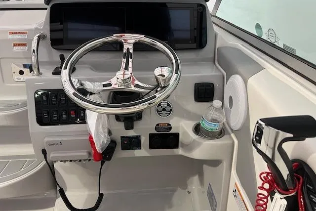 Slide: The Image of Cockpit of 2026 Regal 26 XO boat with steering wheel and control panel. - 8