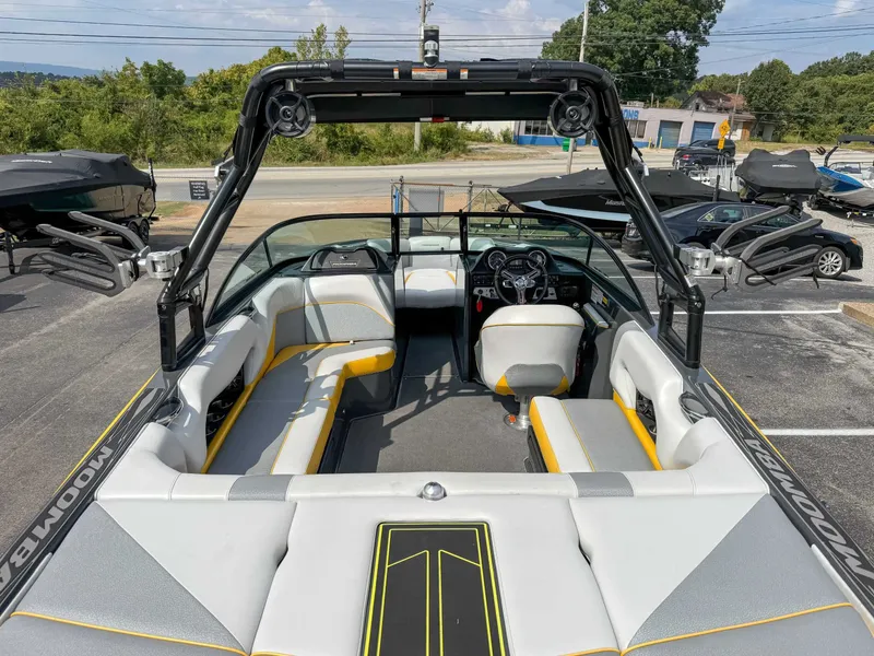 Slide: The Image of 2016 Moomba Craz boat interior with seating and steering wheel, parked outdoors. - 10
