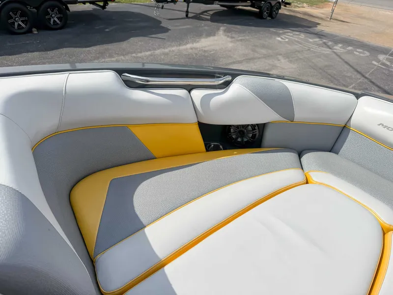 Slide: The Image of 2016 Moomba Craz boat interior with gray and yellow seating, featuring a speaker. - 13