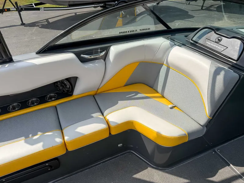 Slide: The Image of 2016 Moomba Craz boat interior with gray and yellow seating, cup holders, and speaker. - 15