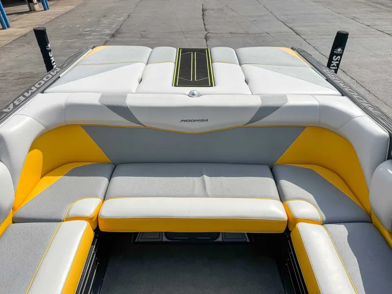 Slide: The Image of 2016 Moomba Craz boat interior with yellow and gray seating on a dock. - 19