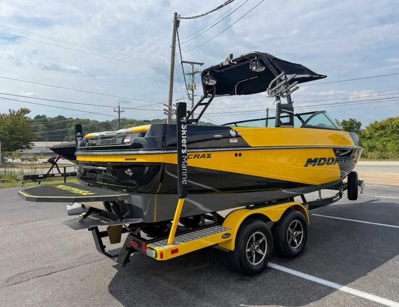 Slide: The Image of 2016 Moomba Craz boat in yellow and black on a trailer, parked outdoors. - 7