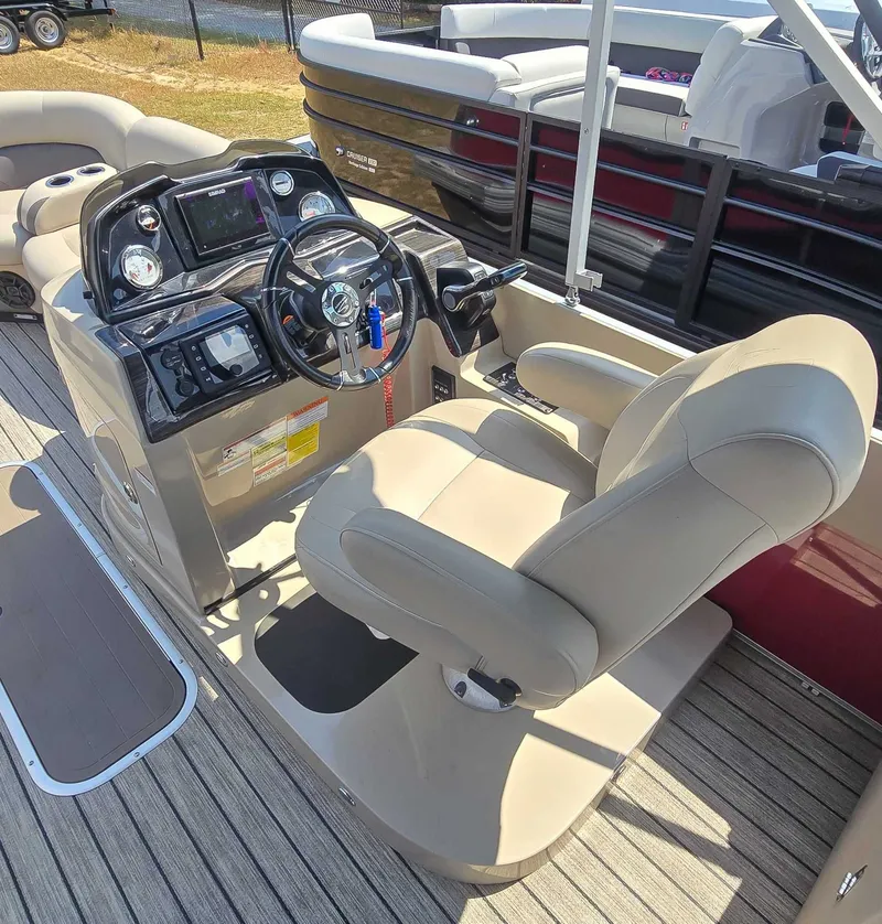 Slide: The Image of Captain's seat and helm of 2020 Landau ATLANTIS pontoon boat, featuring modern controls and steering. - 10