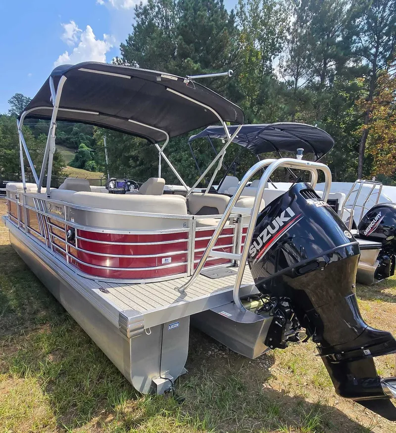 Slide: The Image of 2020 Landau ATLANTIS pontoon boat with Suzuki outboard motor, parked on grass. - 4