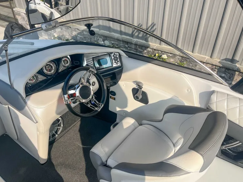 Slide: The Image of 2014 Tigé RZR boat interior with sleek dashboard and modern steering wheel design. - 15