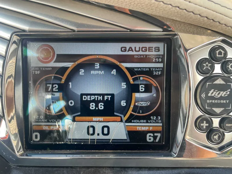Slide: The Image of Dashboard of a 2014 Tigé RZR boat showing gauges and controls. - 17