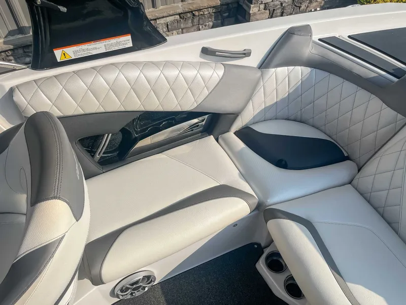 Slide: The Image of 2014 Tigé RZR boat interior with white quilted leather seats and cup holders. - 18