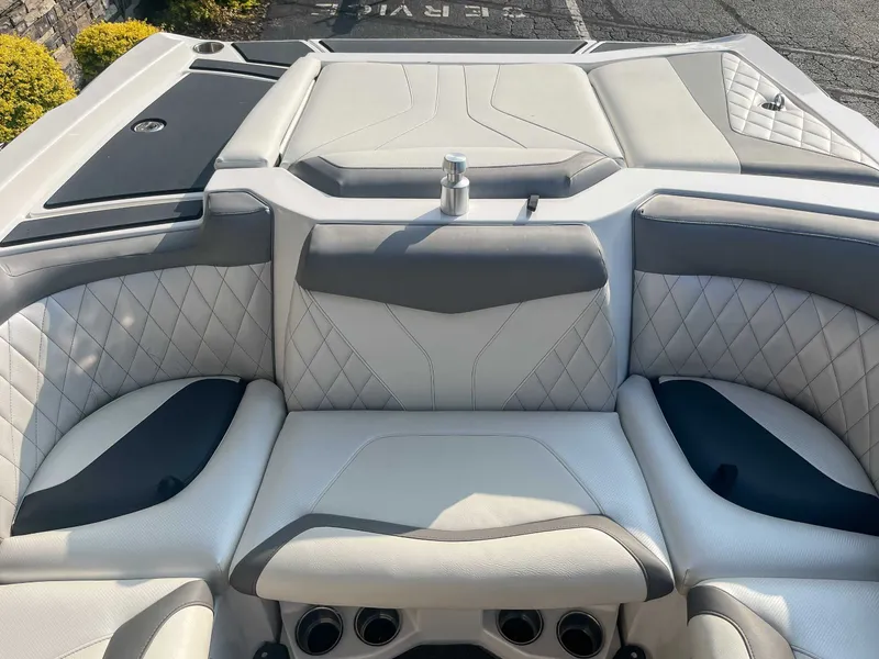 Slide: The Image of 2014 Tigé RZR boat interior with luxurious white and gray seating. - 19