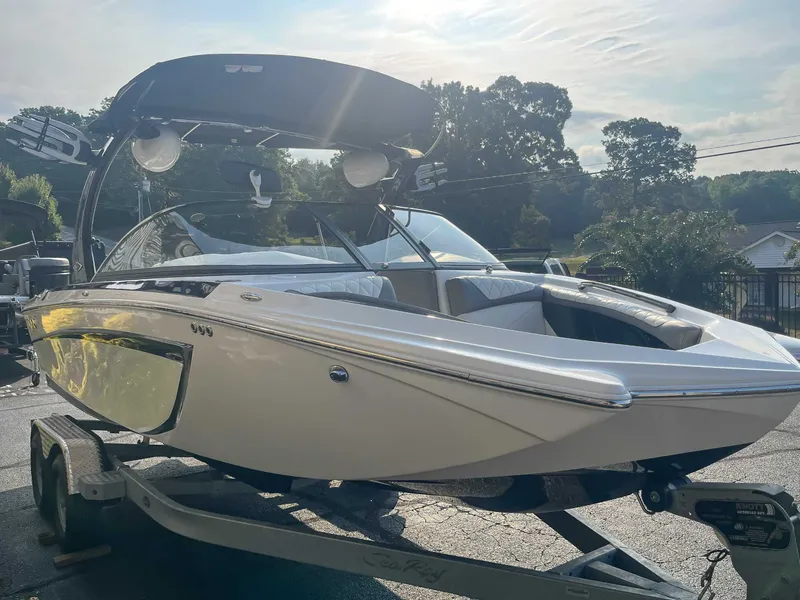 Slide: The Image of 2014 Tigé RZR boat on trailer, sleek design, sunny day background. - 5