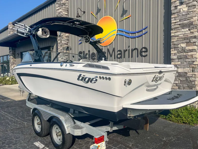 Slide: The Image of 2014 Tigé RZR boat on trailer outside Skier's Marine building. - 6