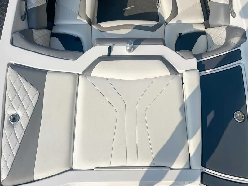 Slide: The Image of 2014 Tigé RZR boat interior with white and gray seating, diamond stitching. - 9