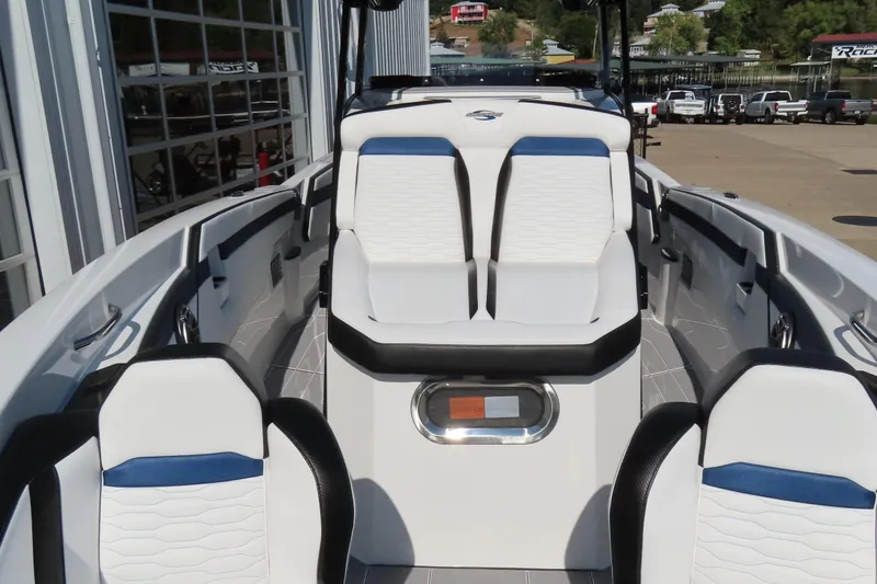 Slide: The Image of 2026 Sunsation 32CCX boat interior with white and blue seating, docked at marina. - 13