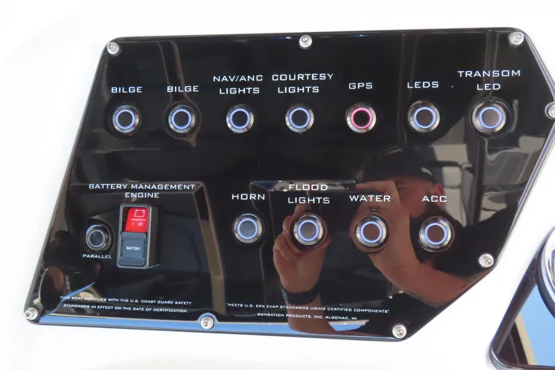 Slide: The Image of Control panel of 2026 Sunsation 32CCX boat with various switches and battery management system. - 21