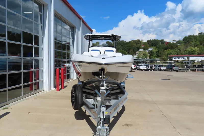 Slide: The Image of 2026 Sunsation 32CCX boat on trailer outside a showroom, under a clear blue sky. - 3