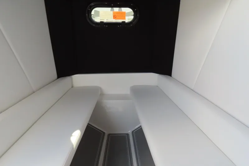 Slide: The Image of Interior cabin of 2026 Sunsation 32CCX boat with white seating and porthole window. - 35