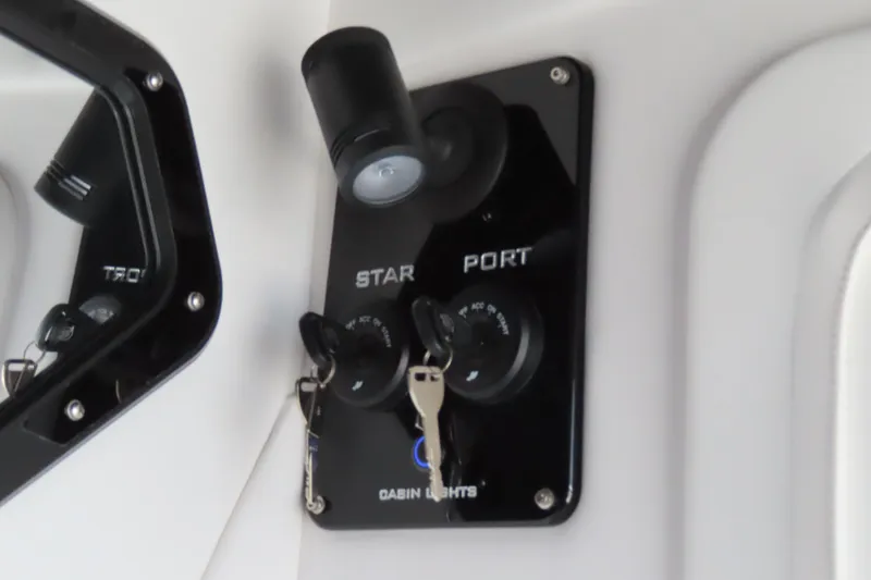 Slide: The Image of Control panel of 2026 Sunsation 32CCX boat with ignition keys and cabin lights. - 37