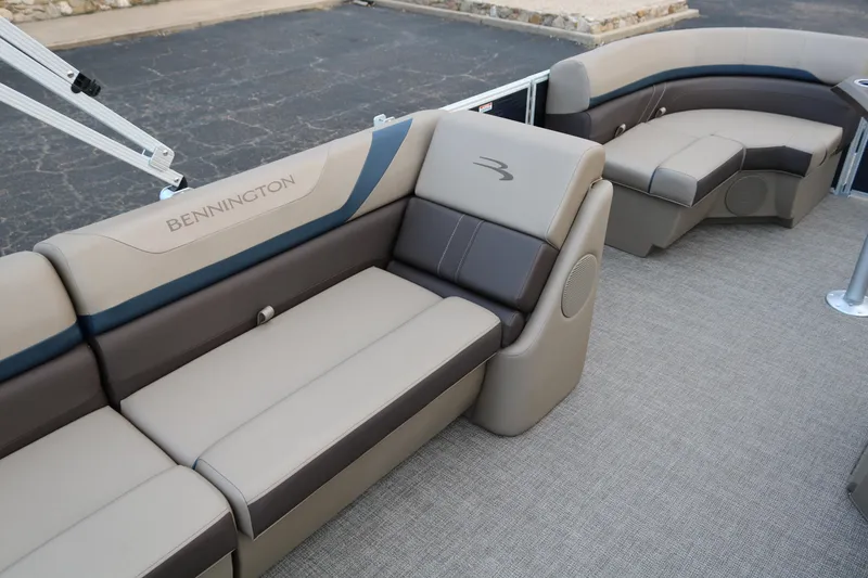 Slide: The Image of 2026 Bennington 20SSRCX boat with open storage compartment and cushioned seating. - 18
