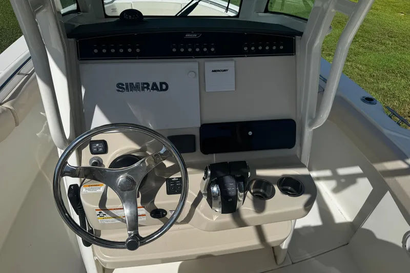 Slide: The Image of 2019 Boston Whaler 26 Outrage helm with Simrad electronics and Mercury controls. - 14