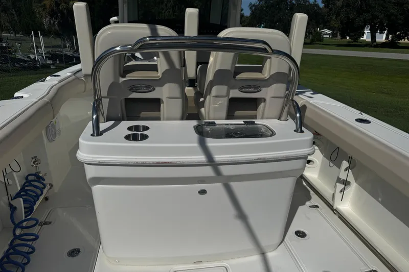 Slide: The Image of 2019 Boston Whaler 26 Outrage boat interior with seating and storage features. - 15