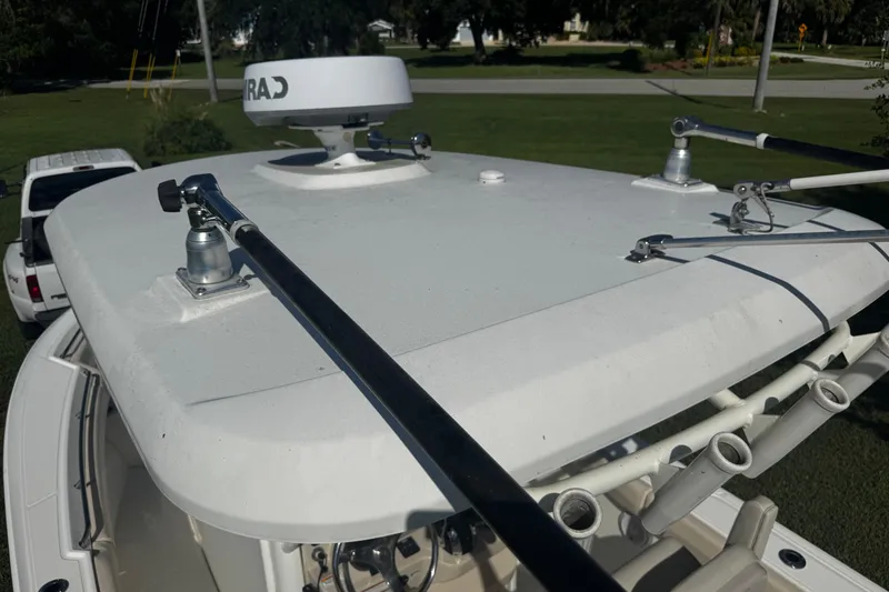 Slide: The Image of 2019 Boston Whaler 26 Outrage boat roof with radar and rod holders. - 16