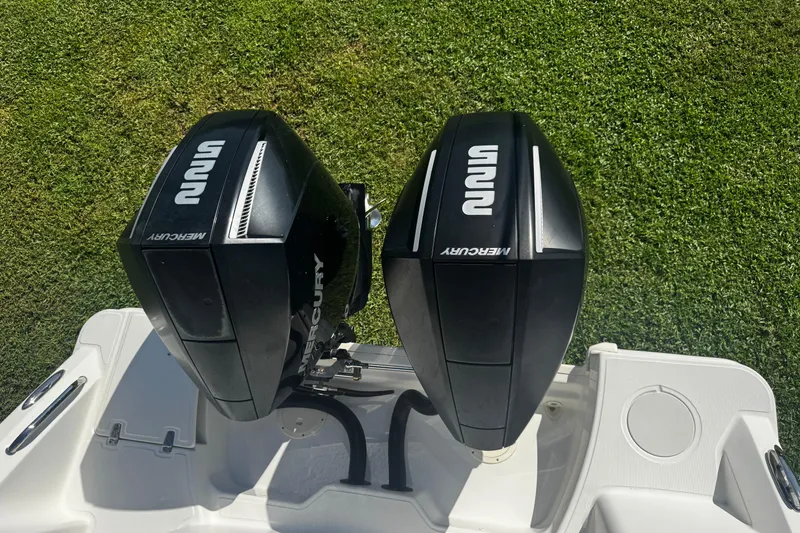 Slide: The Image of Twin Mercury outboard engines on a 2019 Boston Whaler 26 Outrage boat. - 18