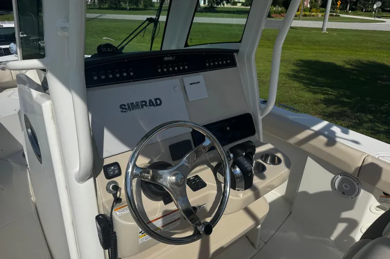 Slide: The Image of 2019 Boston Whaler 26 Outrage helm with Simrad electronics and steering wheel. - 4