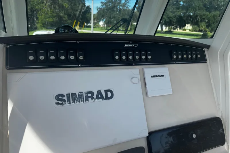 Slide: The Image of Control panel of a 2019 Boston Whaler 26 Outrage boat with Simrad and Mercury equipment. - 7