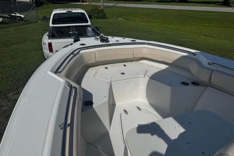 Slide: The Image of 2019 Boston Whaler 26 Outrage boat interior with white truck in background. - 9
