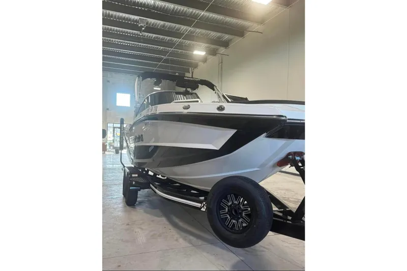Slide: The Image of 2019 MasterCraft XT22 boat on trailer in indoor showroom. - 2