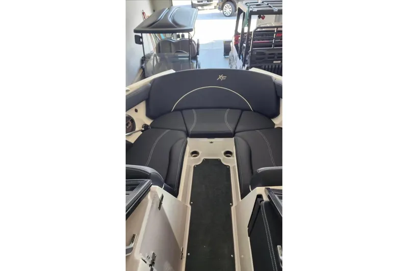 Slide: The Image of 2019 MasterCraft XT22 boat interior with black seating and sleek design. - 3