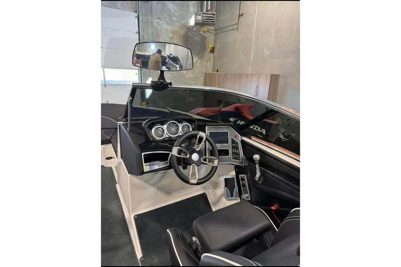 Slide: The Image of 2019 MasterCraft XT22 boat interior with steering wheel and dashboard controls. - 4