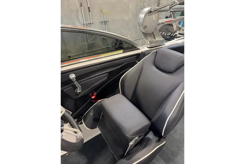 Slide: The Image of 2019 MasterCraft XT22 interior with sleek black seating and modern controls. - 5