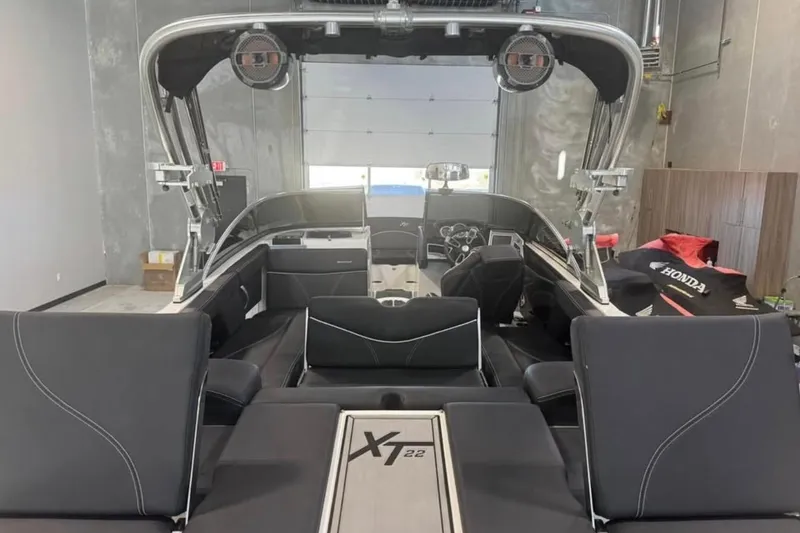 Slide: The Image of 2019 MasterCraft XT22 boat interior with sleek black seating and modern design. - 6