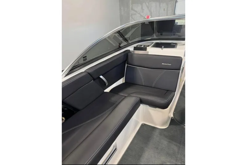 Slide: The Image of 2019 MasterCraft XT22 boat interior with sleek black seating and modern design. - 7