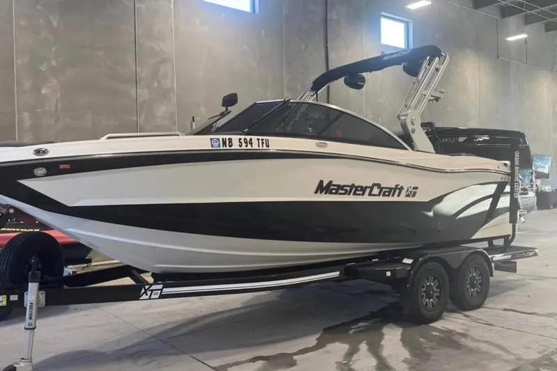 Slide: The Image of 2019 MasterCraft XT22 boat on trailer in indoor storage facility. - 8