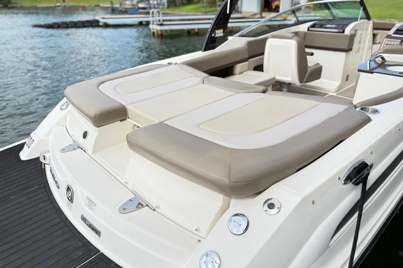 Slide: The Image of 2013 Sea Ray 250 SLX boat with spacious seating, docked by a serene lake. - 11