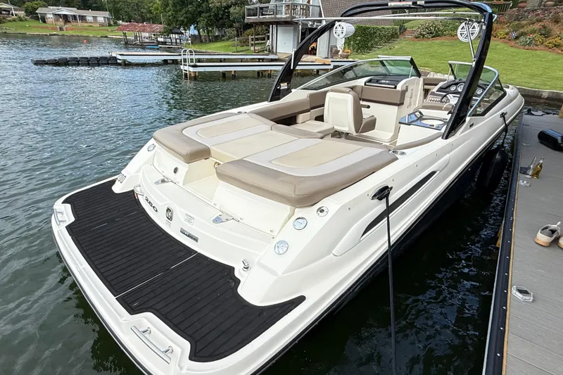 Slide: The Image of 2013 Sea Ray 250 SLX boat docked on a serene lake. - 12