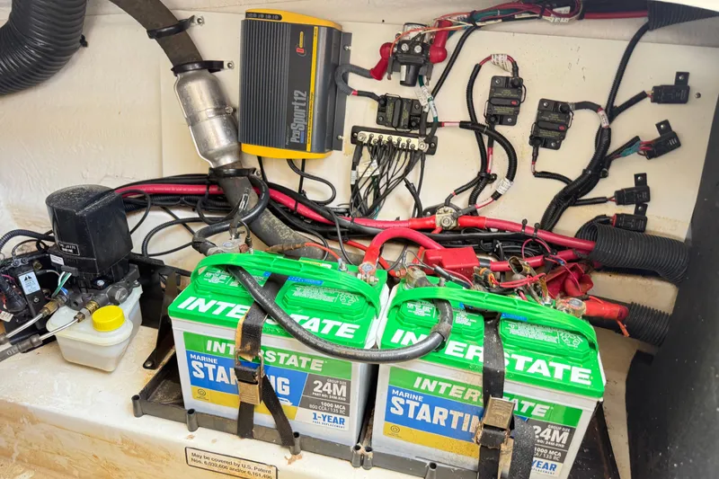 Slide: The Image of Electrical system of a 2013 Sea Ray 250 SLX with Interstate marine batteries and wiring components. - 13